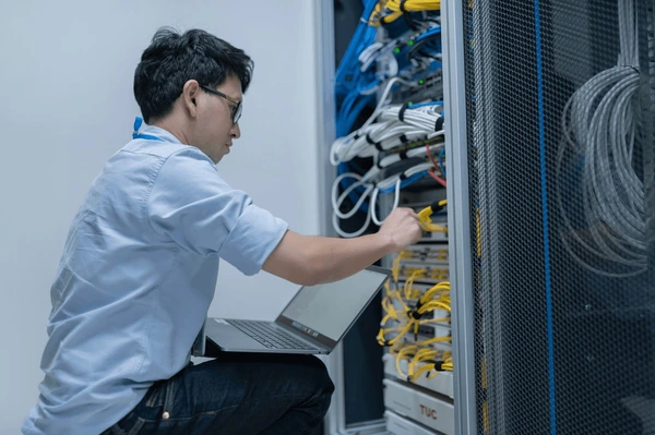 Computer engineer setting up network server room systems Malaysia